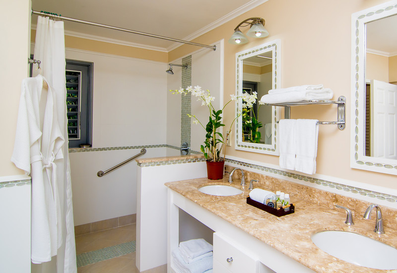 Its handicap accessible bathroom features a double vanity and seamless entrance walk-in shower.