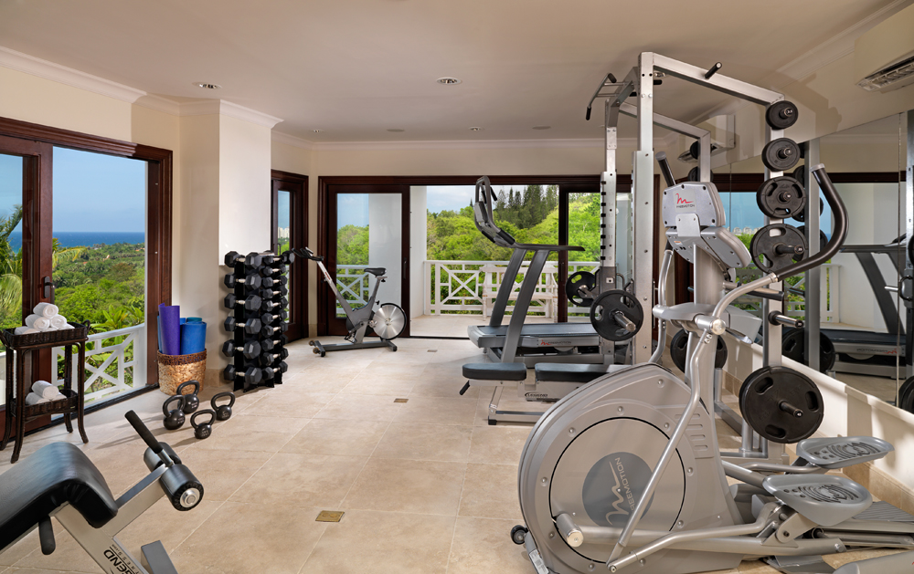 To stay in shape given the marvelous meals prepared by your personal chef ... wander through the downstairs corridor to the air-conditioned gym. Work out on the incliner trainer treadmill, do
