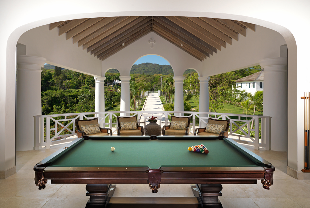 Beyond the TV sitting area is a favorite of all generations: the classic pool table with a view of the peak of the eponymous Flower Hill for which the home is named.