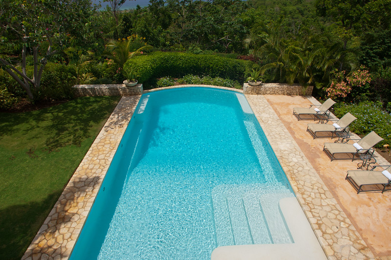 ... over a long, sun-drenched symmetrical pool ...