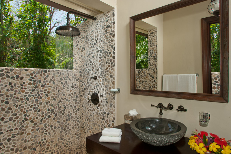 Thoughtful planning led to the full bathroom just few barefoot steps beyond the pool and bar.